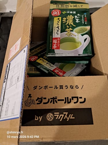 Customer's multiple green pouches of Itoen Green Tea Matcha Powder inside an open shipping box.