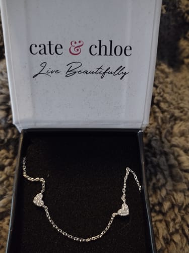 Customer's beautiful Irene Heart Station Necklace displayed inside its open Cate & Chloe gift box.