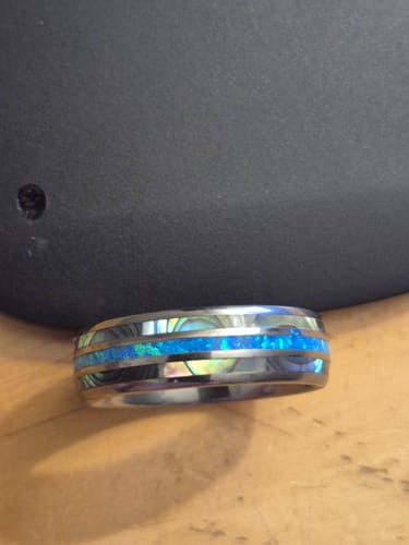 Reviewer's close-up of the Vanguard ring, showing the vibrant blue opal and abalone inlays.