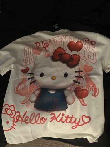 Reviewer's white tee with a large Hello Kitty graphic, laid out flat.
