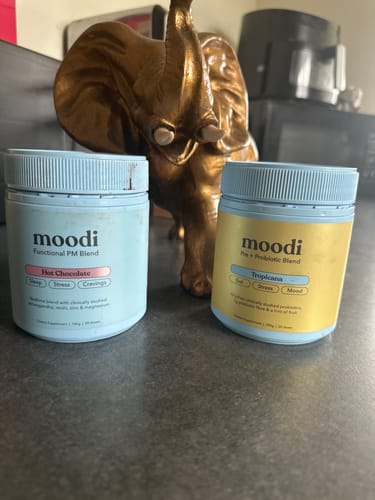 Customer's tub of Tropicana Pre + Probiotic Blend on a counter next to another tub of Moodi product.