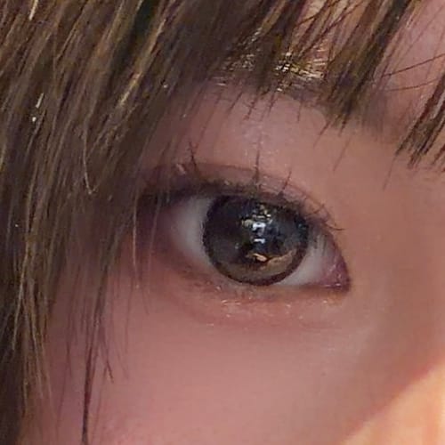 レビューアーの目元のクローズアップ。「Cat-titude Kristin 1Day - チョコポウ」を着用し、キラキラした大きな瞳になっています。
