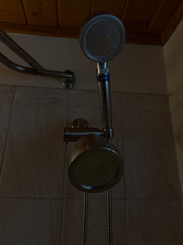Customer's 3-Way Shower Arm Diverter installed, holding a handheld wand above a fixed shower head.