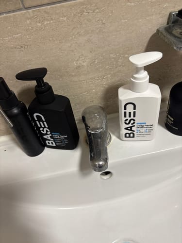 Customer's Refreshing Trio products, in black and white pump bottles, arranged on a bathroom sink.