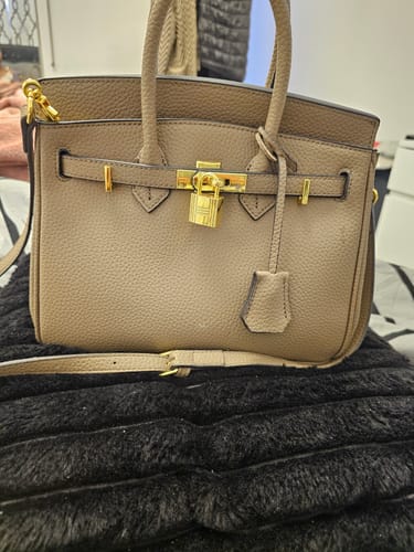Customer's taupe Warkin Bag, showing the pebbled leather, gold hardware, and lock closure.