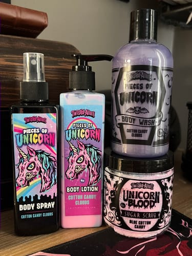 Reviewer's Pieces of unicorn Body Spray shown with the matching body lotion, body wash, and sugar scrub.