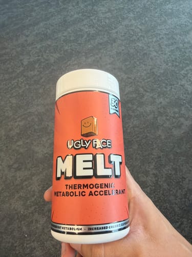Customer holding the orange and white bottle of UGLYFACE MELT thermogenic supplement.