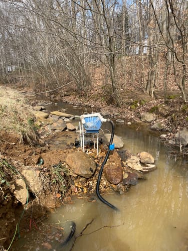 Customer's Transformer Sluice Box highbanker kit set up on rocks in a Carolina mountain creek.