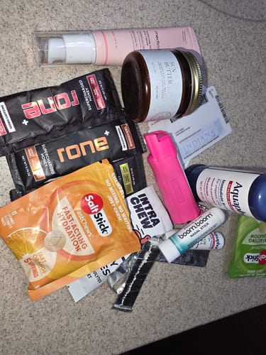 Customer's SuperCharged Honey packets shown in a pile with other various wellness products on a counter.