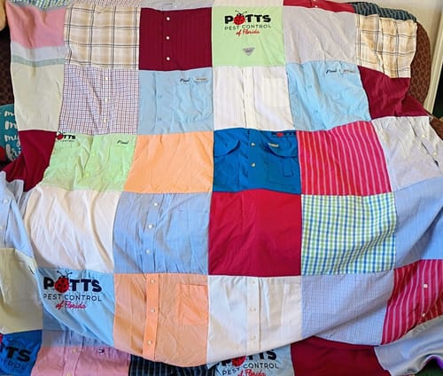 Customer's colorful Project Repat T-Shirt Quilt made from various button-down and logo shirts.