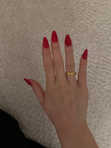 Kunde zeigt den schicken, goldenen Amore Zirconia Ring an der Hand.