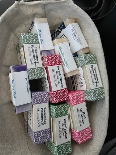 Customer's cloth bag filled with various soaps, including the Passion Fruit Natural Soap.