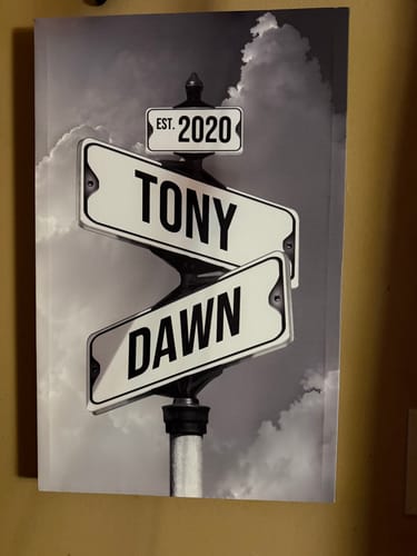 Customer's personalized black and white canvas with street signs showing the names Tony, Dawn, and the date 'Est. 2020'.
