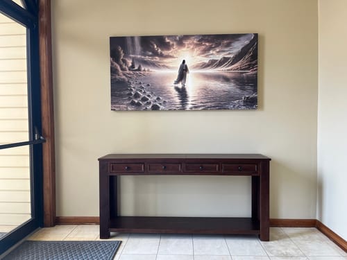 Customer's 'Walking on Water' wall art hanging in a church foyer above a wooden console table.