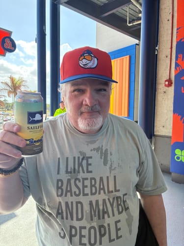Reviewer at an outdoor stadium wearing the 'I Like Baseball and Maybe 3 People' t-shirt.