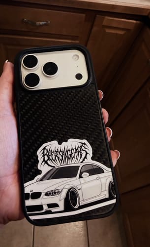 Reviewer's custom vinyl sticker of a white car, seen on a phone case.