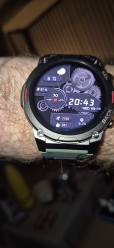 Close-up of a customer's Gard Pro Ultra 2+ watch on their wrist, with a detailed digital face showing time, date, and health metrics.