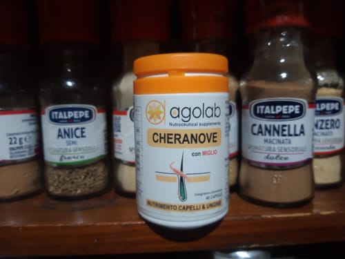 Flacone di Cheranove del recensore su uno scaffale di legno in una dispensa.