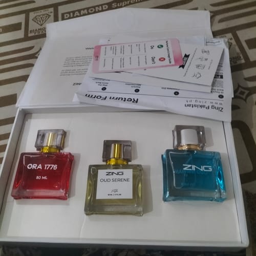 Customer's OUD Supreme BUNDLE showing the red Ora 1776, clear Oud Serene, and blue Oud Nirvana bottles in the open box.