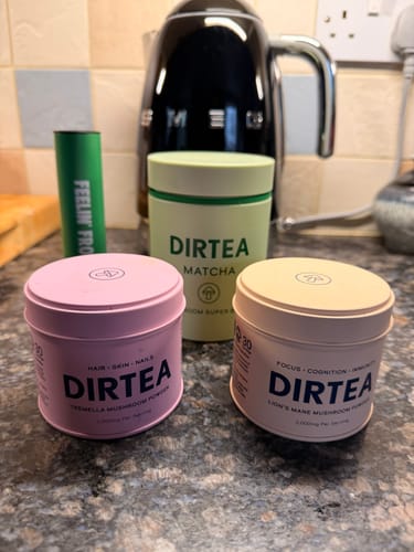 Customer's DIRTEA Matcha, Lion's Mane, and Tremella mushroom powders arranged on a kitchen counter.