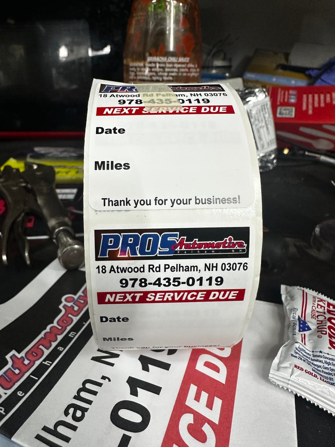 Customer photo review of Custom Oil Change Stickers for Windshield with Logo