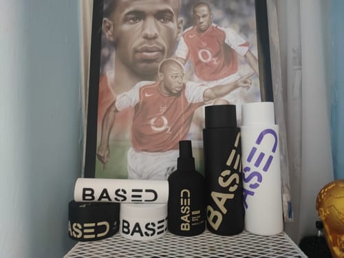 Customer's collection of 'BASED' hair products, including the conditioner and shampoo, displayed on a shelf.