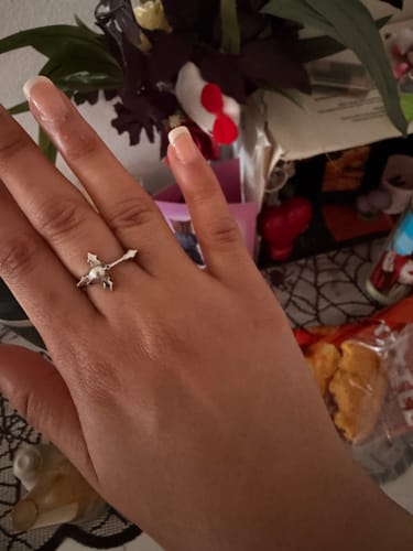 Customer showing the silver MINI DYT RING worn on their index finger against a blurred background.