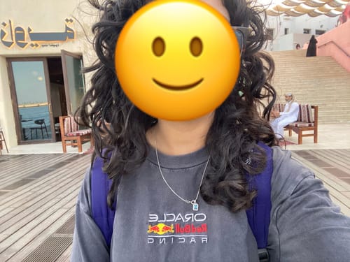Reviewer shows their defined, non-frizzy curls after using the Leave-in Curl Conditioner.
