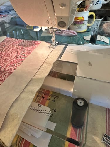 Customer using the transparent Sew Steady Extension Table for quilting on a sewing machine, showing the helpful printed ruler.