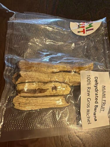Reviewer's package of tan, Dehydrated Gros Michel Bananas in a clear, vacuum-sealed bag.