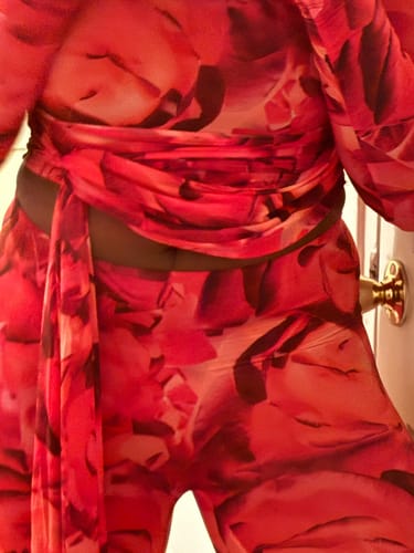 Close-up of a reviewer wearing the red Bare Body Print Leggings with the matching top.