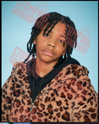 Close-up of a customer wearing the Faux Fur Leopard Zip Up Hooded Coat with the hood up.