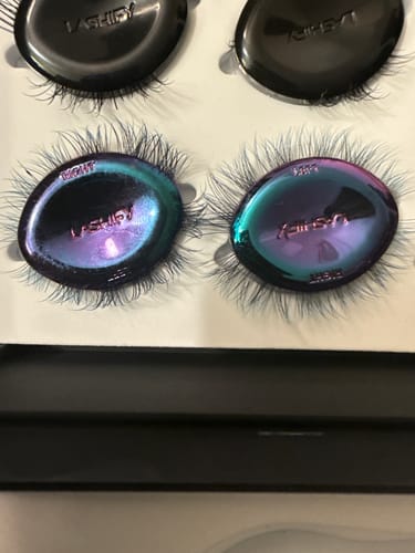 Reviewer's Plushy Ombre Gossamer® Lashes with teal tips shown in their unique, metallic oil slick packaging.