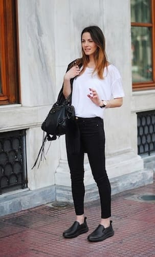 Reviewer standing outdoors wearing the black slip-on Dry Fit shoes with black pants and a white t-shirt.