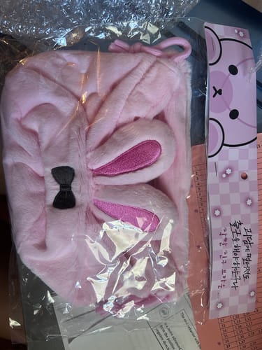 Customer's soft, pink 'Good Friend' pouch shown in its original plastic packaging.