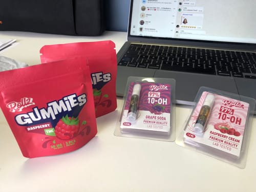 Customer's two red pouches of ROLLZ THC gummies displayed on a desk next to a laptop.