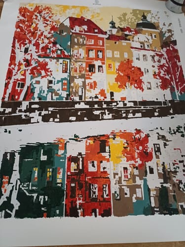 Customer's Prague paint by number canvas, a vibrant work in progress showing colorful buildings and their reflection.
