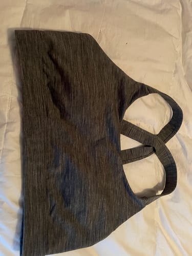 Customer's Livi Bra in Graphite Heather laid on a white surface, showing the side and double cross-back straps.