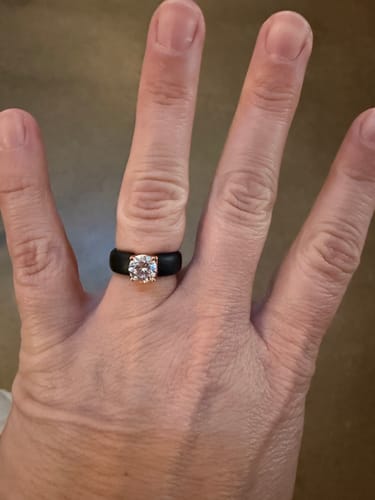 Customer's hand wearing the black silicone ring with a large, round solitaire CZ stone.