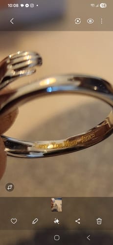 Close-up of a customer's Hug From Heaven Ring with the personal engraving 'Love You Mum - James' inside.