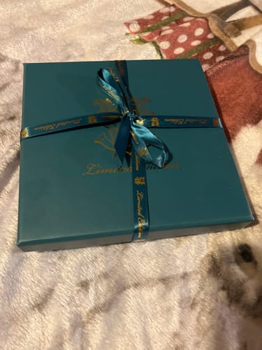 Customer's Limited Edition Discovery Set in its elegant teal gift box, tied with a decorative ribbon.