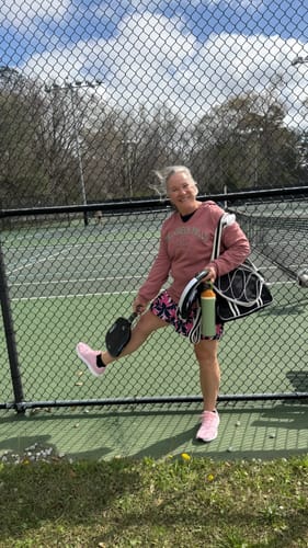 Reviewer at a pickleball court wearing the pink Flow Wide Toe Box Pickleball Shoes.