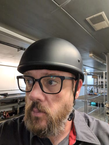 Reviewer wearing the flat black SOA Beanie helmet, showing its low-profile fit.