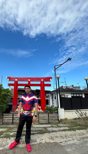 Reviewer standing outdoors in bright pink Adizero EVO SL running shoes.