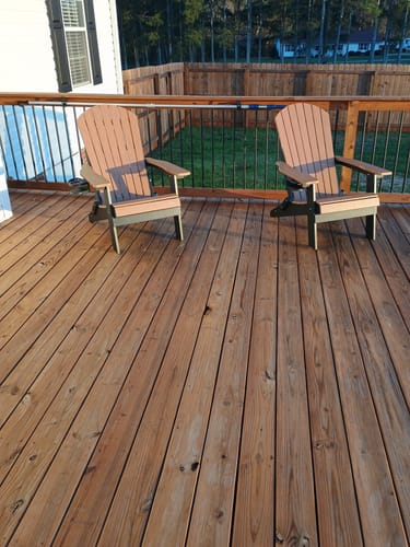 Customer's two two-tone Folding Adirondack Chairs sitting on a wooden back deck.