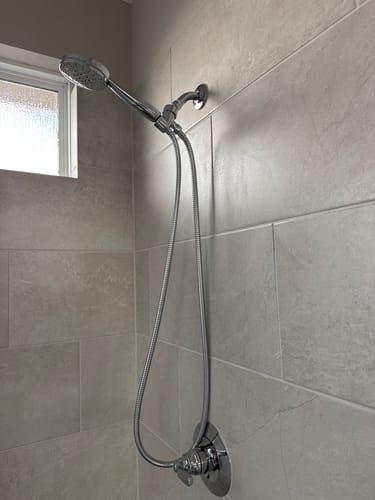 Customer's installed 3-Spray Handheld Shower Head Set on a tiled shower wall.