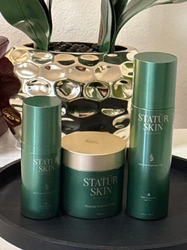 Customer's complete Restoration Ritual Set, with three matching green skincare products arranged on a tray.