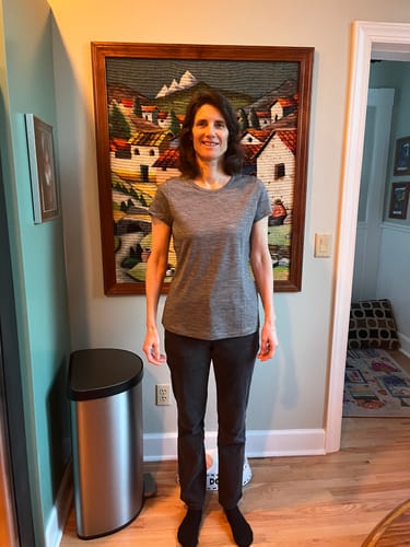 Reviewer showing the fit of the Graphite Heather Addie Crew Neck shirt indoors.