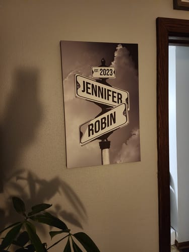 Customer's 'Couples Date of Love' canvas on a wall. It's a black-and-white print of street signs with names 'Jennifer' and 'Robin'.