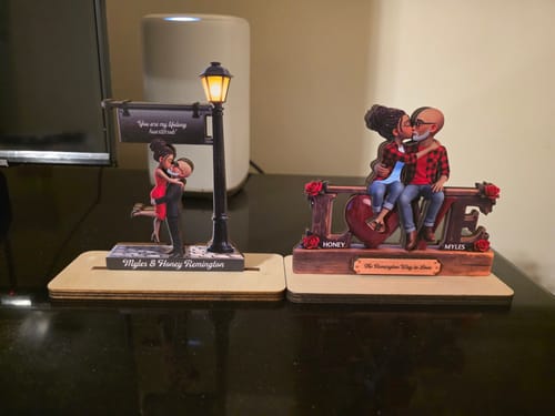 Customer's 'Timeless Love' plaque with a glowing lamp post displayed on a desk next to another personalized plaque.